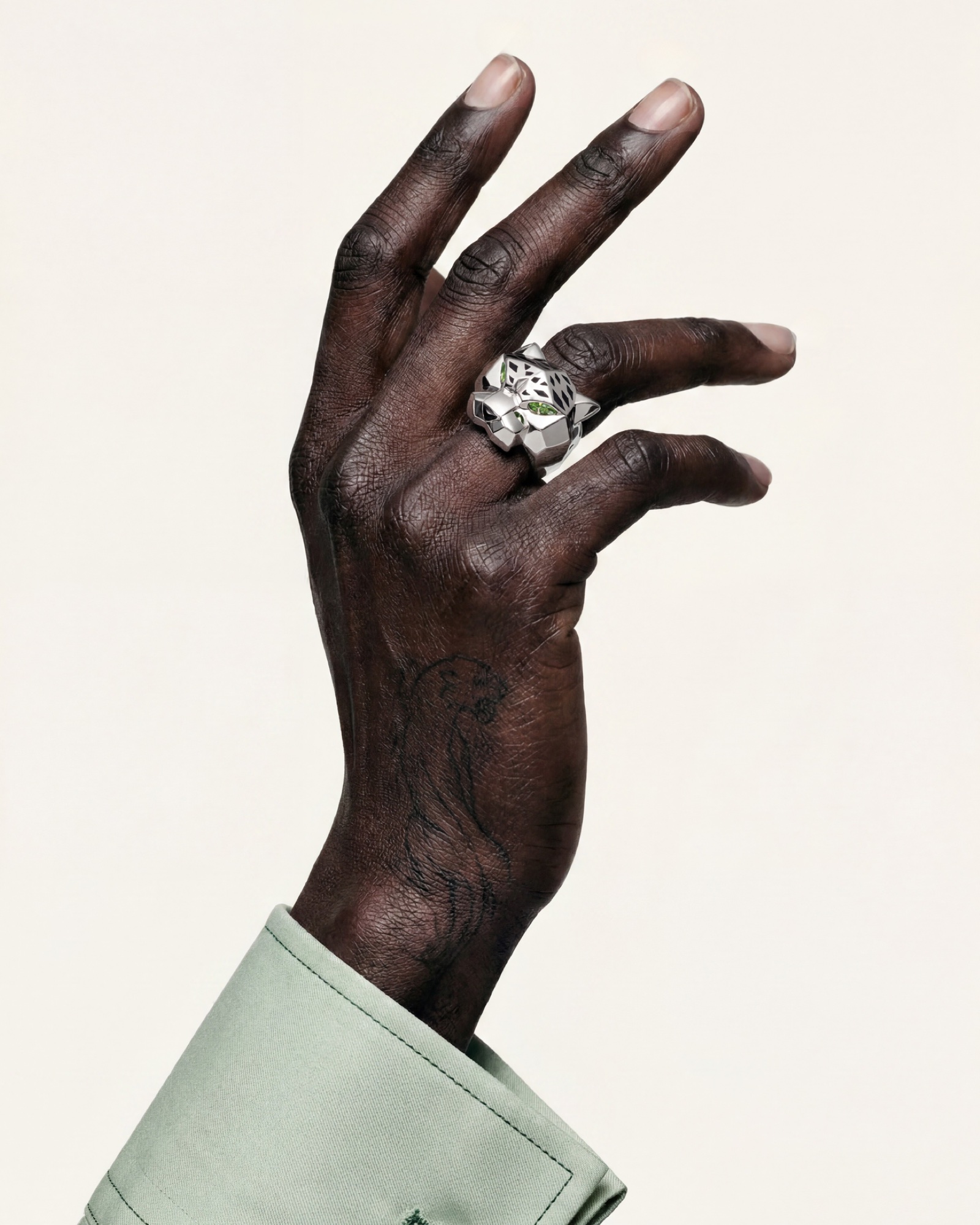 A hand turning, green cuff at the wrist