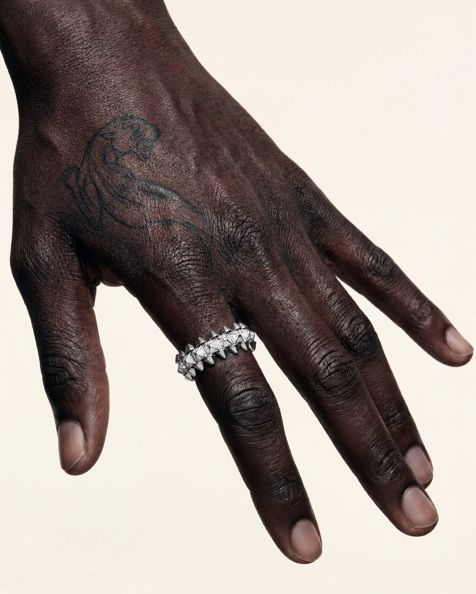 A hand at rest, the tattooed panther running across the back of it