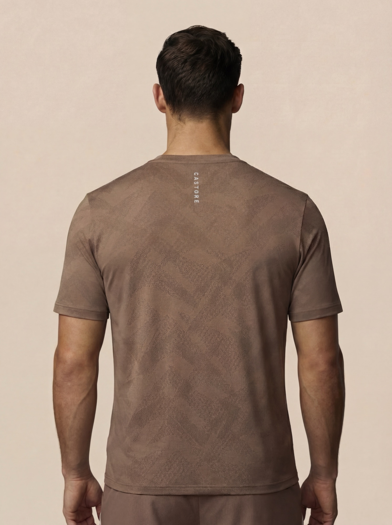Castore knit tee, back view with vertical wordmark