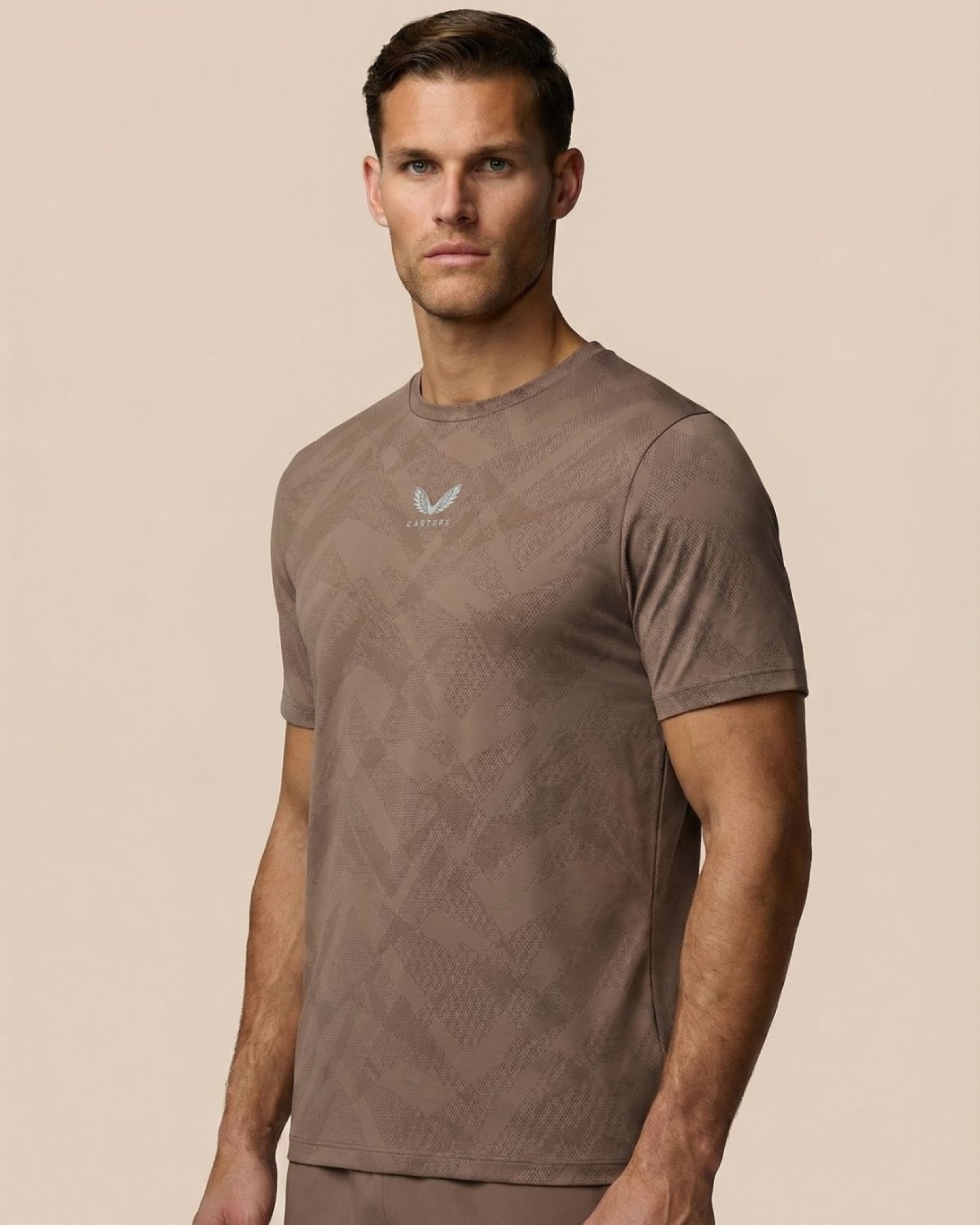 Castore engineered-knit tee, full length on a neutral ground