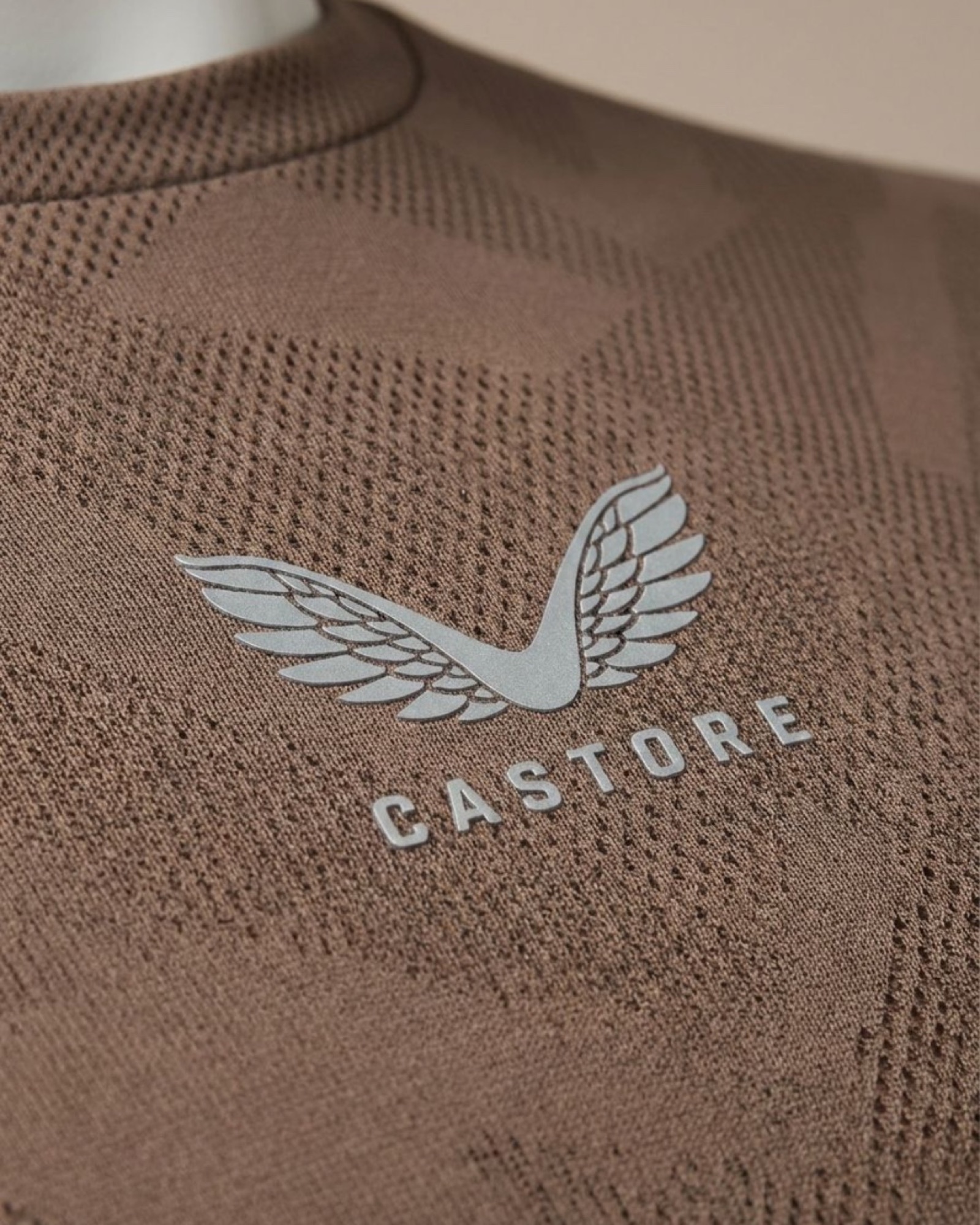 Macro detail of the Castore wing mark on engineered knit