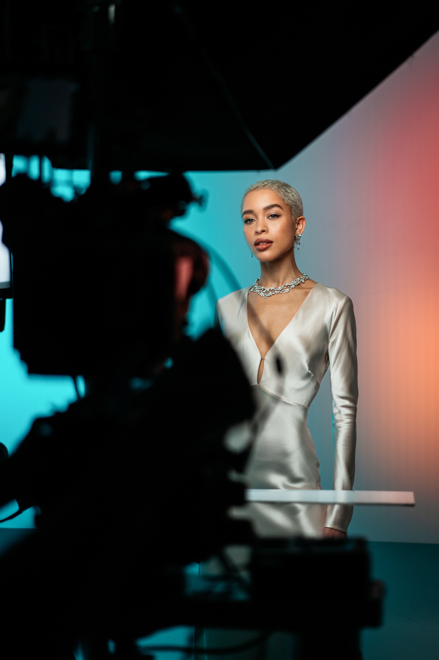 The model framed past the camera body