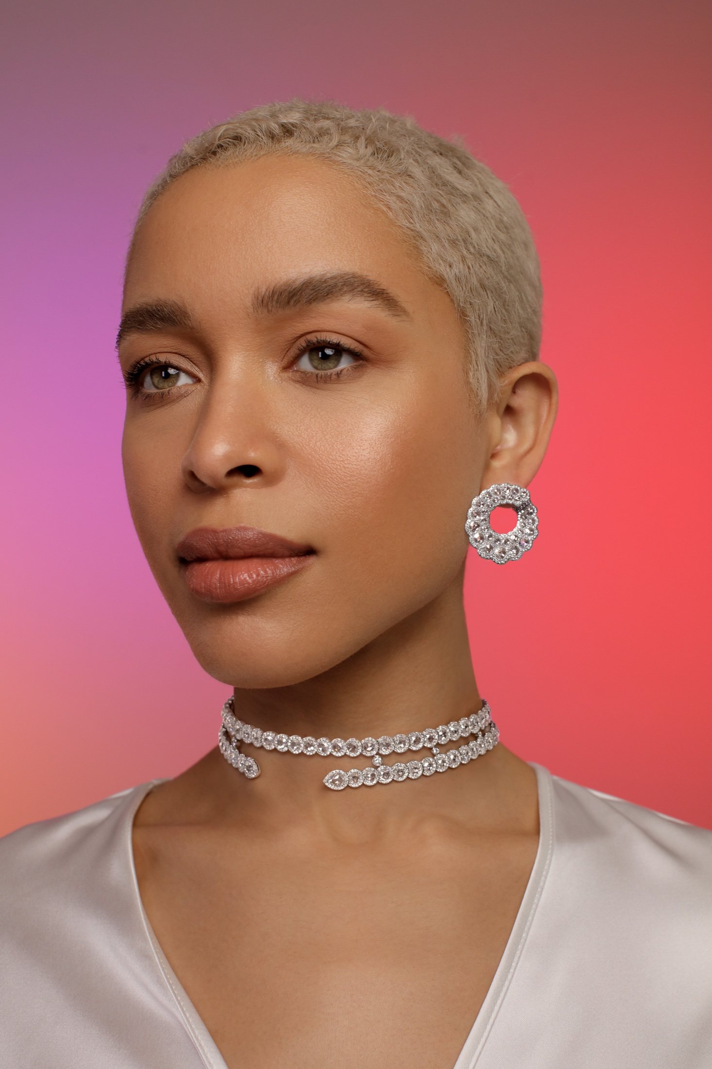 Diamond choker and drop earrings on a red gradient