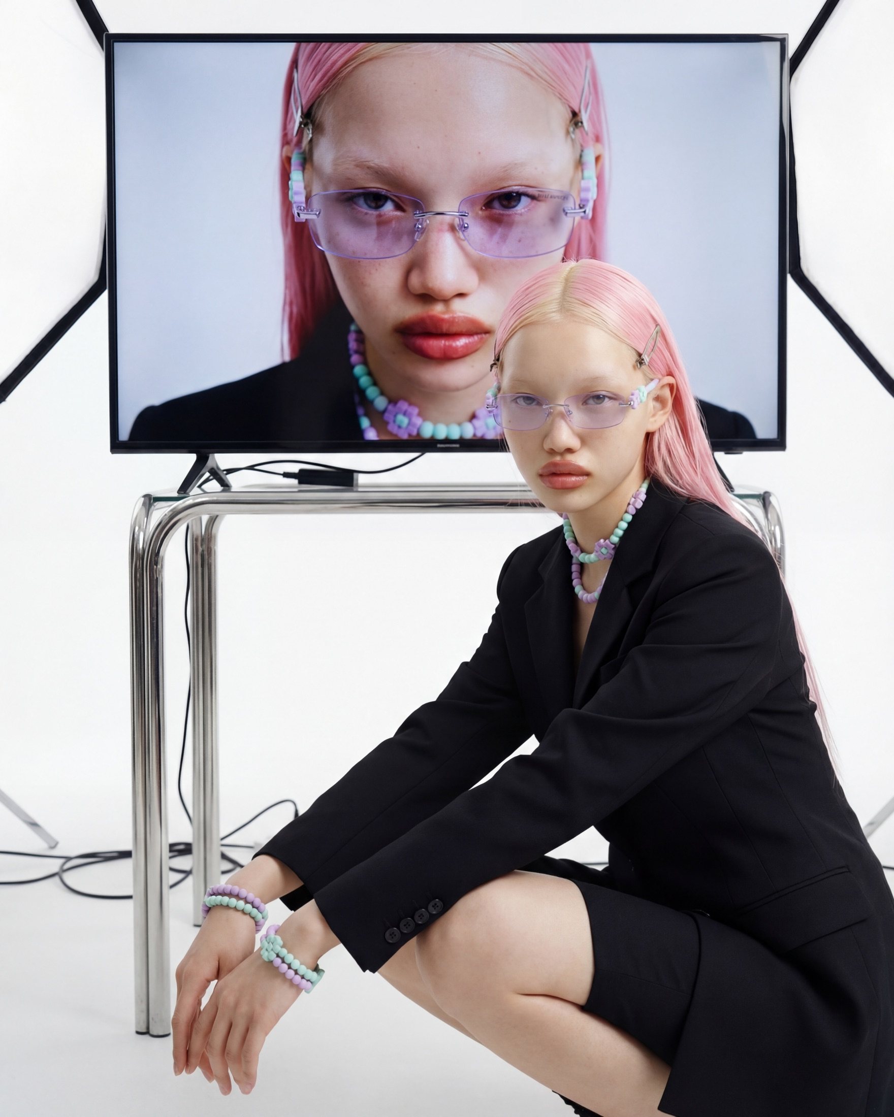 Studio environment, model in front of a monitor showing the Digital Romance campaign frame