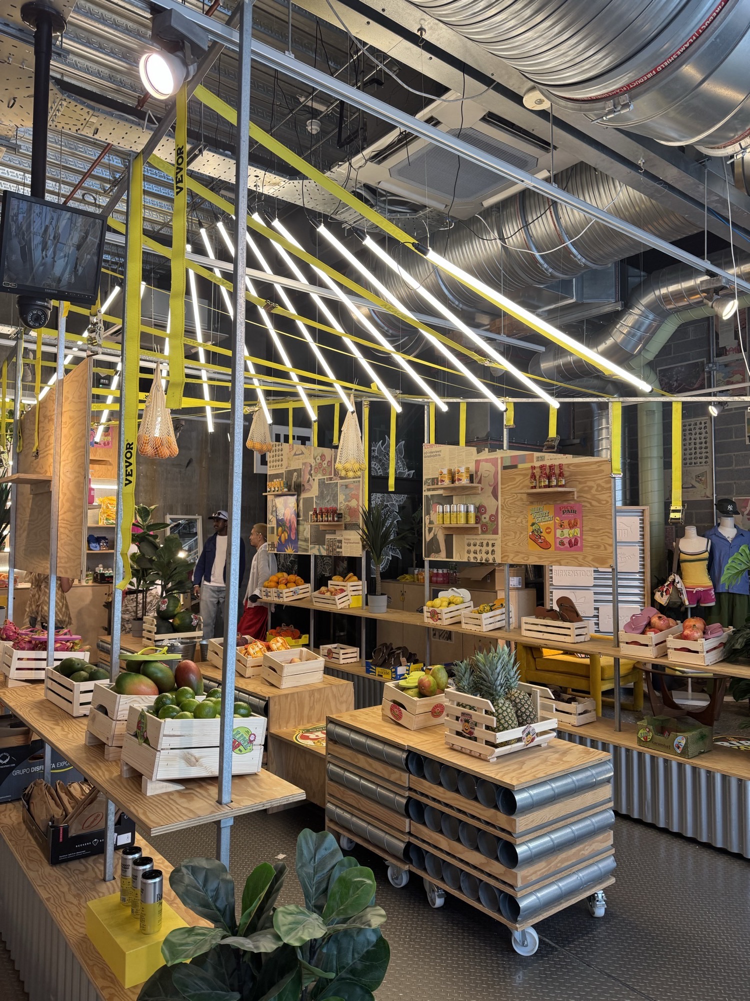 The fruit stand built out in yellow steel, stocked with produce and product
