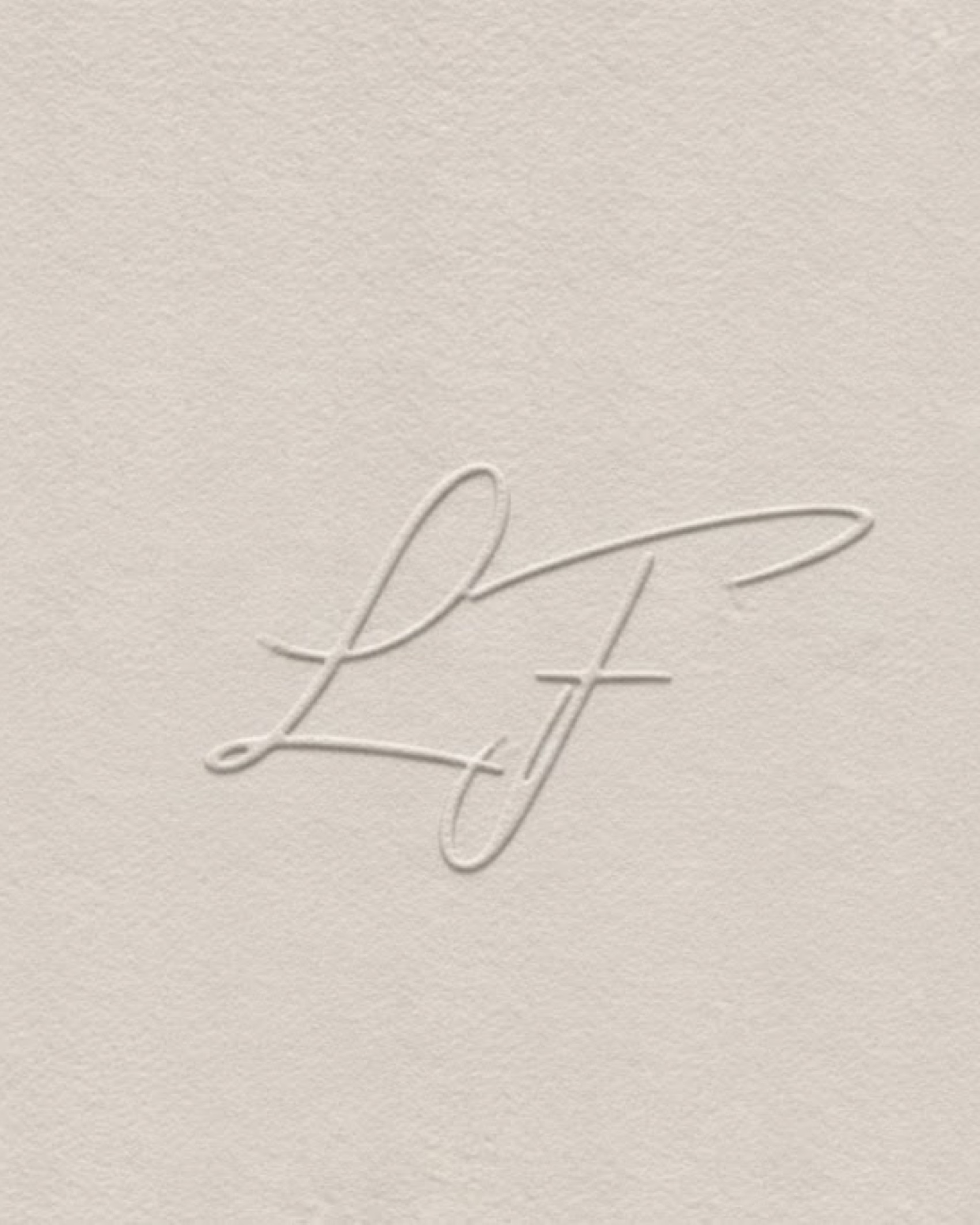 The monogram blind-embossed into uncoated stock