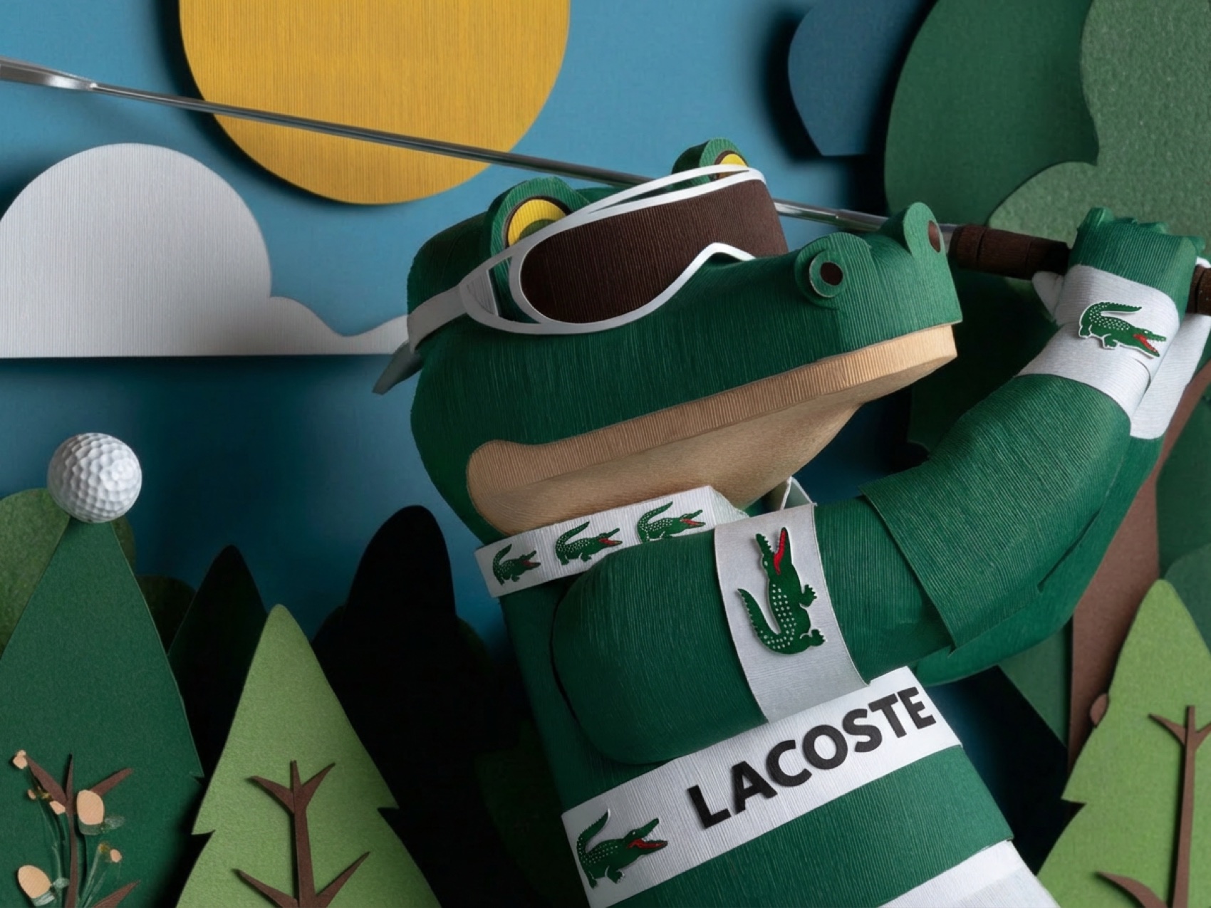 The paper crocodile mid-swing in a striped polo
