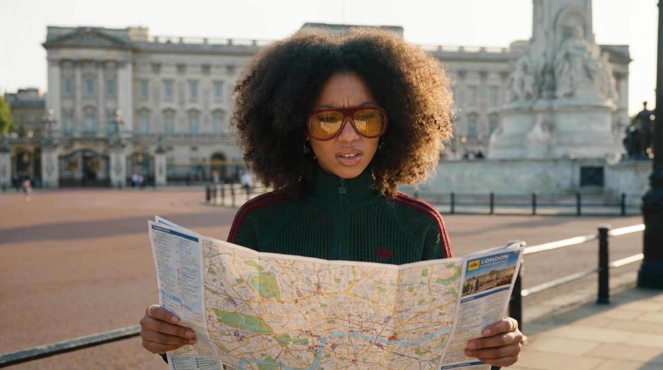 The model reading a London map in front of the Palace