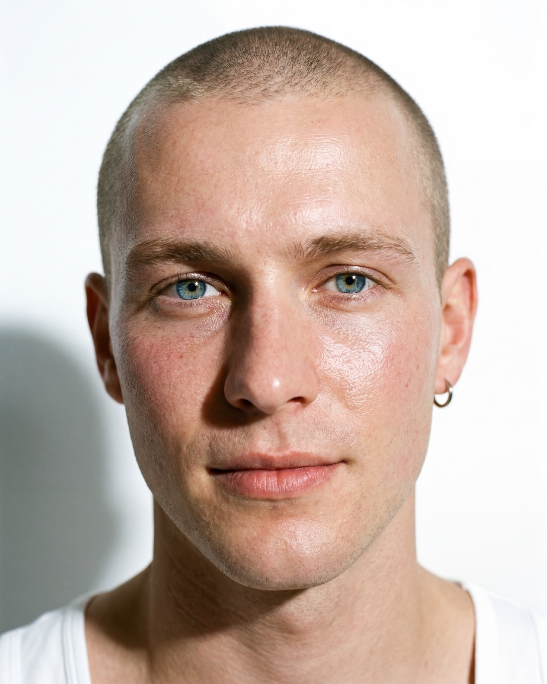 Casting portrait: shaved head, pale blue eyes