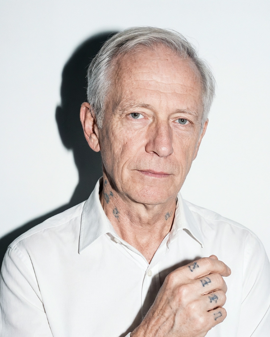 Casting portrait: silver hair, hand tattoos